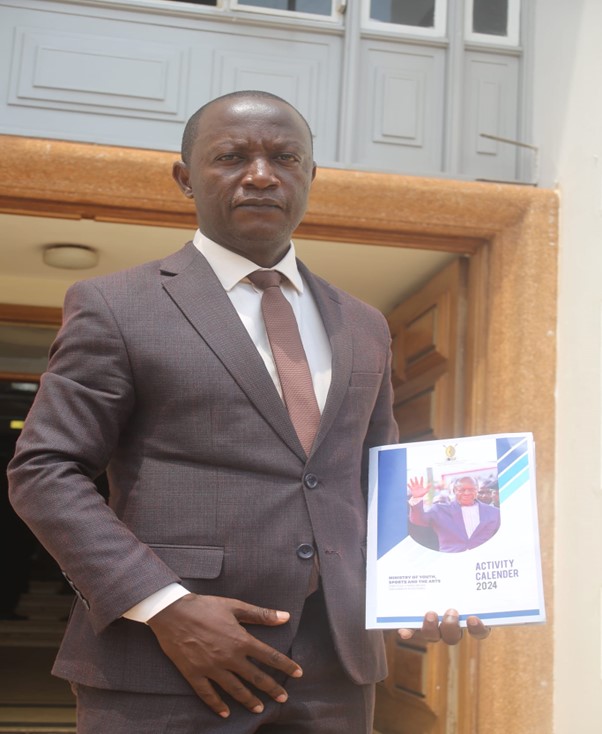 Hon. Ssaalongo Sserwanga Robert holding the roadmap and master plan Booklet Image