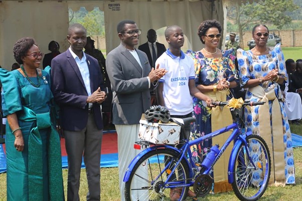 Student Newton Kasasa was presented with a bicycle as a gift for being the best student Student Newton Kasasa was presented with a bicycle as a gift for being the best student