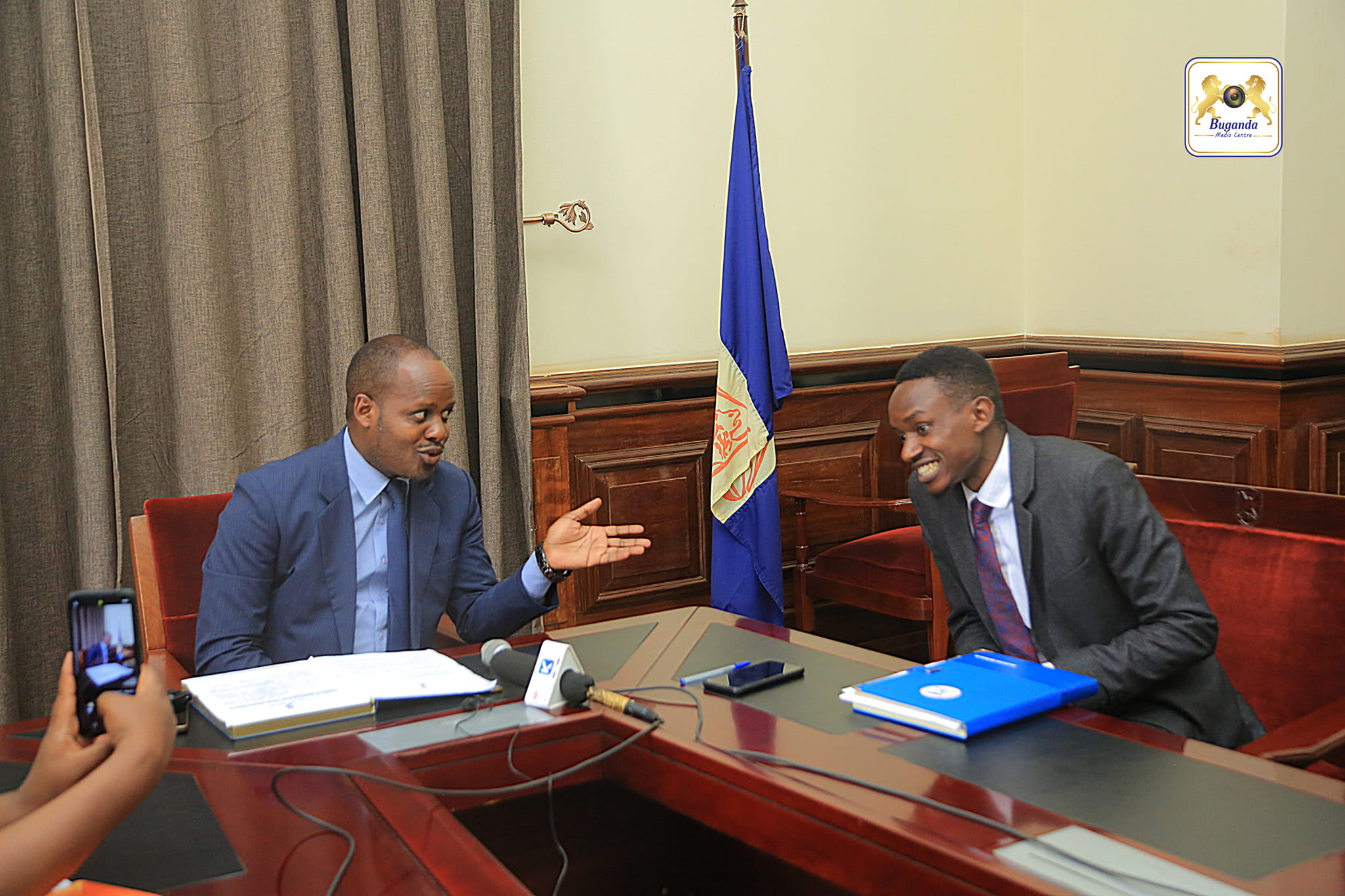 Information Minister Hon. Israel Kazibwe Kitooke was interacting with a journalist Information Minister Hon. Israel Kazibwe Kitooke was interacting with a journalist