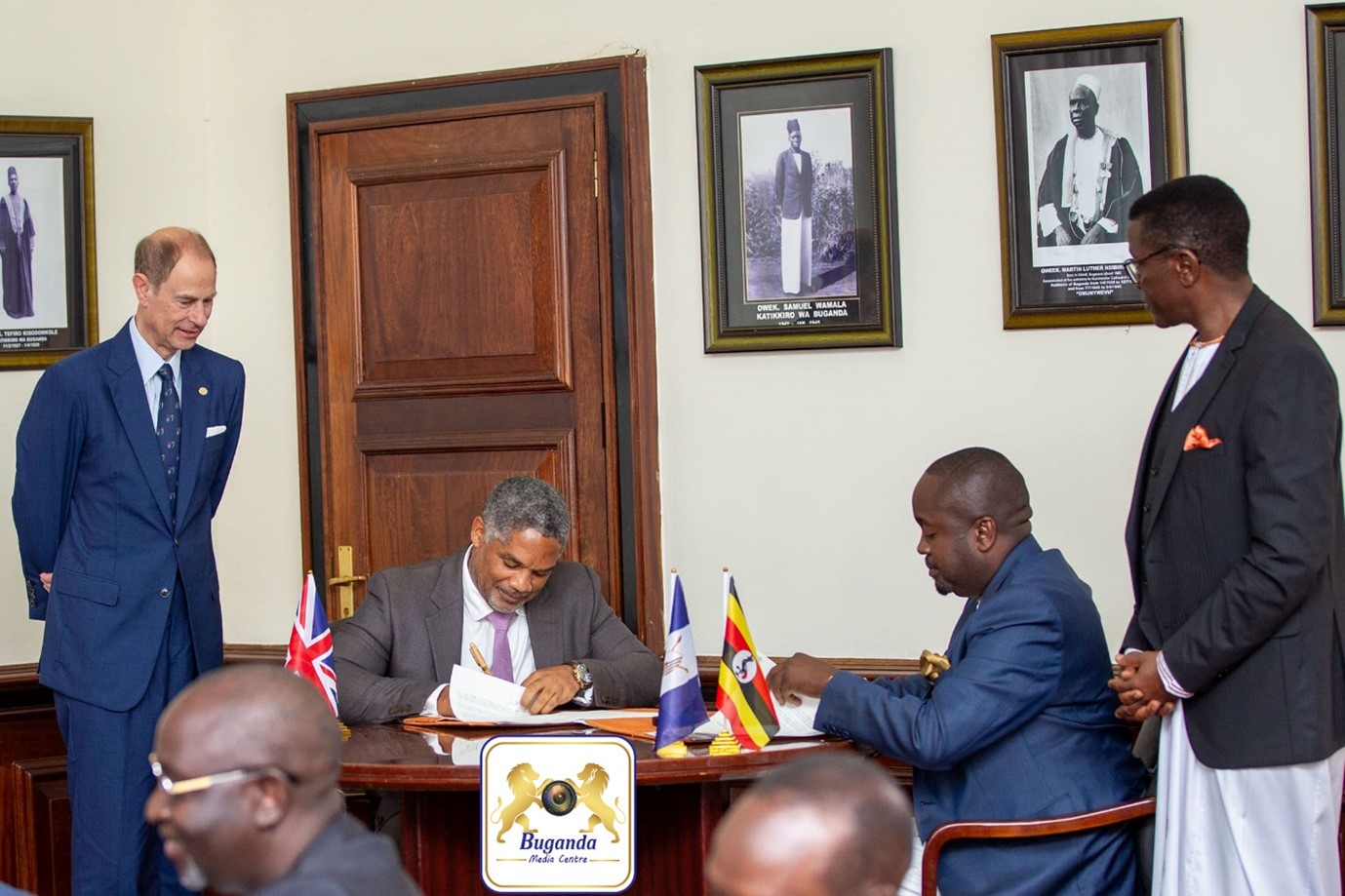 Prince Edward on the left and the Prime Minister on the right watching the MOU being signed. Prince Edward on the left and the Prime Minister on the right watching the MOU being signed.
