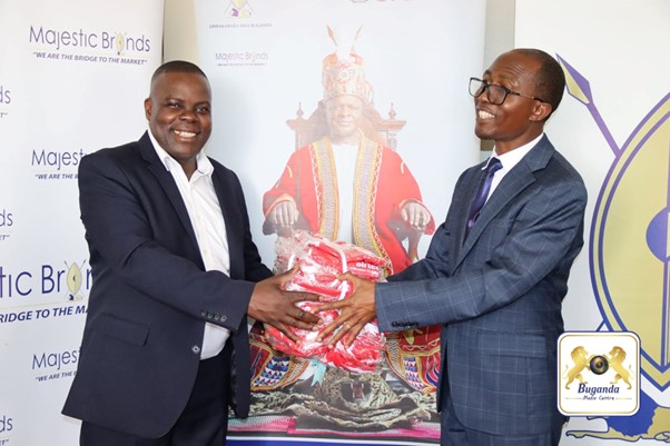 Hon. Godfrey Sekisonge was receiving jerseys from Hon. Joseph Kawuki for the Kabaka's Birthday Run Image