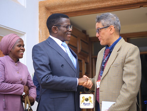 The prime minister (on the left ) bidding farewell to the MD Tropical Bank Image