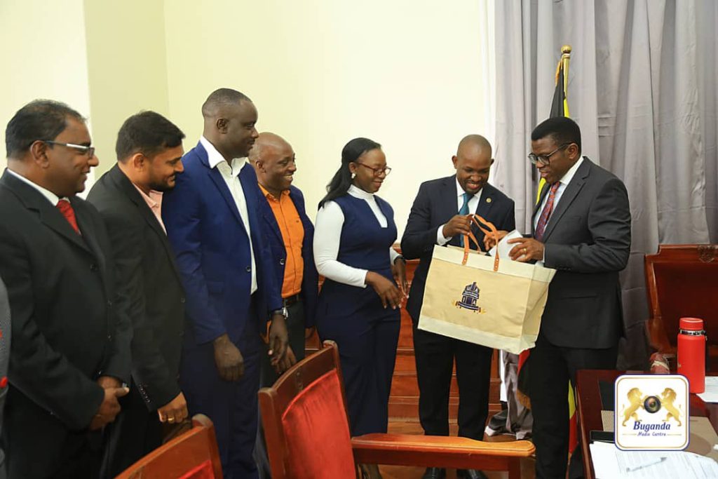 Alcohol Industry Association members, presenting a gift to the Katikkiro Alcohol Industry Association members, presenting a gift to the Katikkiro