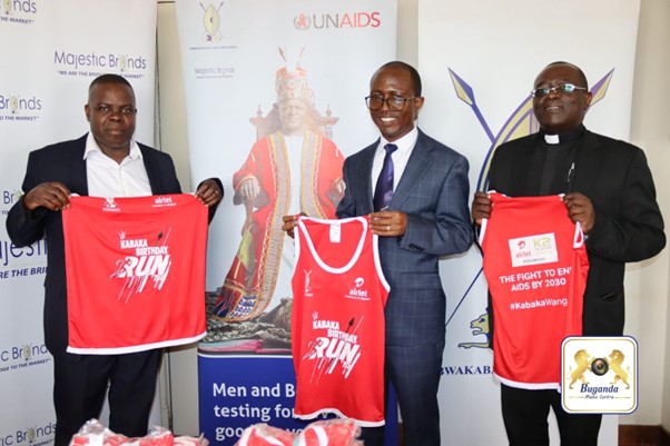 from the left Hon.Sekisonge Godfrey Sekisonge followed by Hon.Min. Joseph Kawuki in the middle holding shirts for the Kabaka birthday run from the left Hon.Sekisonge Godfrey Sekisonge followed by Hon.Min. Joseph Kawuki in the middle holding shirts for the Kabaka birthday run