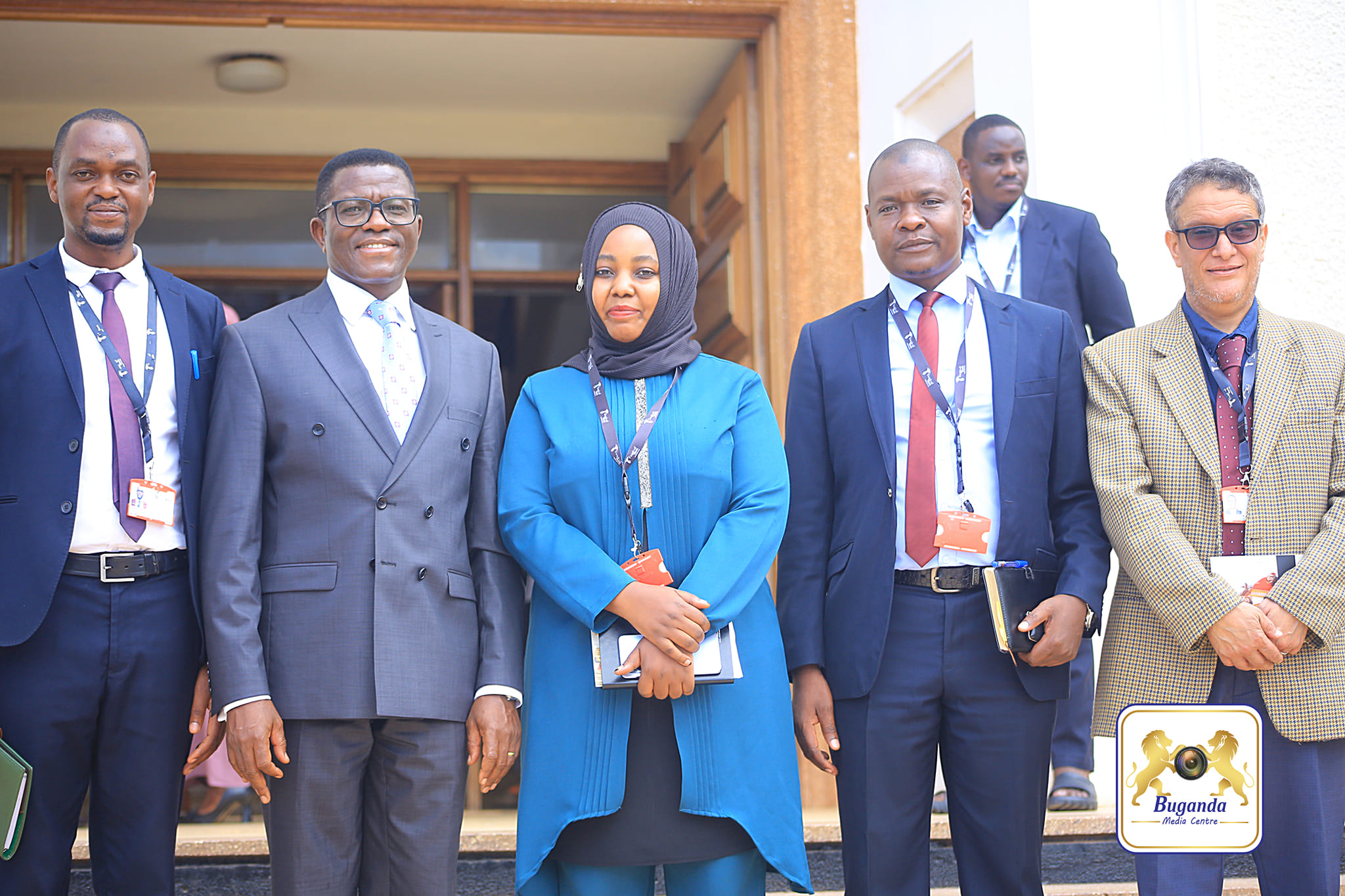 The Katikkiro poses for a group photo with a team from Tropical Bank Image
