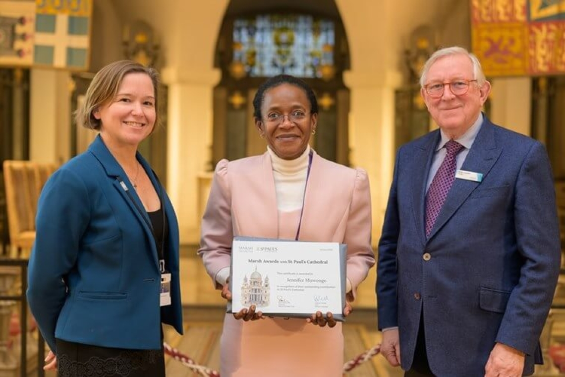 Jennifer Muwonge (centre) receiving the award Jennifer Muwonge (centre) receiving the award