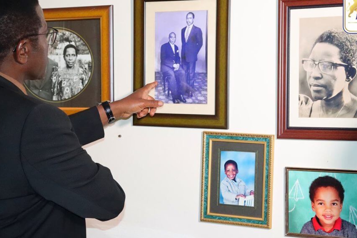 Katikkiro Mayiga points at the portrait of the late Amb. Matovu on the wall Katikkiro Mayiga points at the portrait of the late Amb. Matovu on the wall