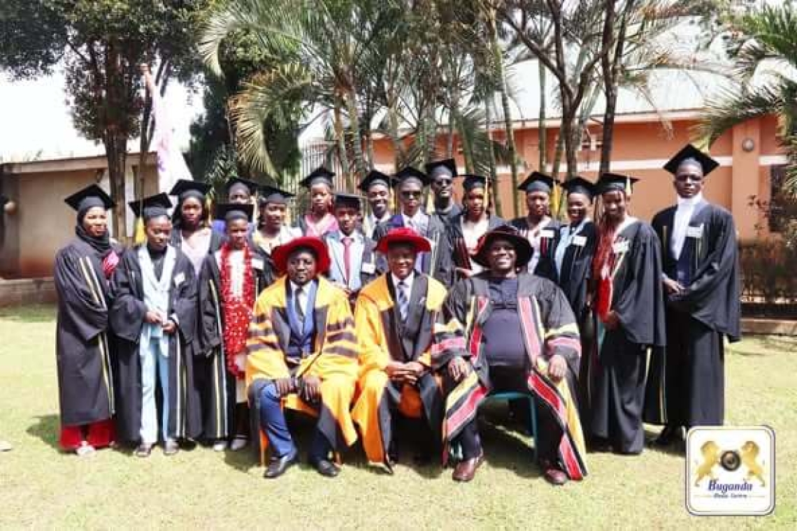 Hon. Kiyimba is in the middle, seated with school leaders as graduates stand behind them Hon. Kiyimba is in the middle, seated with school leaders as graduates stand behind them