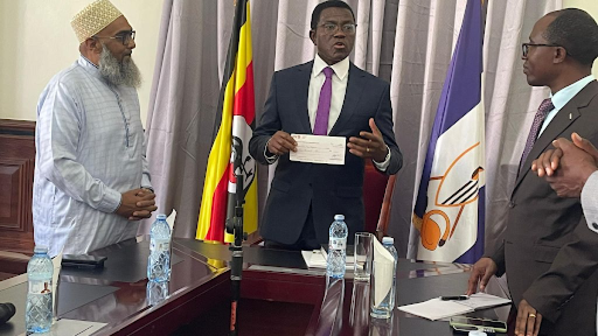  Katikkiro Charles Peter Mayiga receives a $1,000 donation from Fakhruddin Properties of Dubai to support well drilling in Buganda.