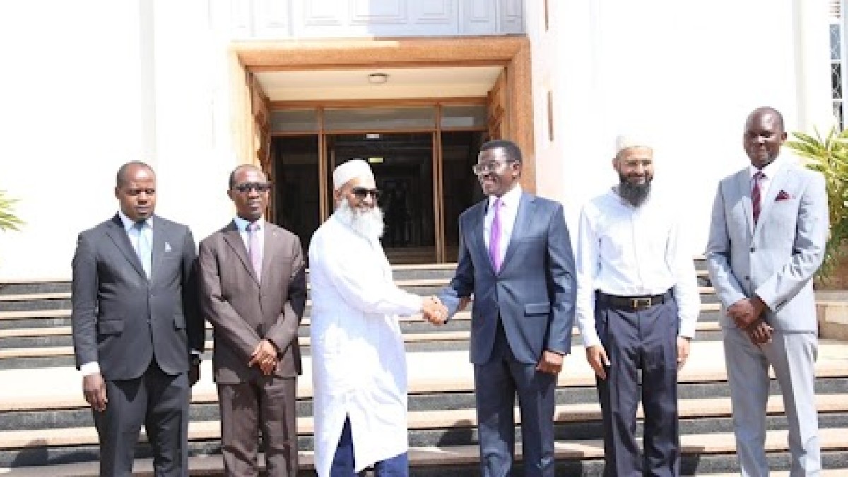 Katikkiro Charles Peter Mayiga receives a $1,000 donation from Fakhruddin Properties of Dubai to support well drilling in Buganda.