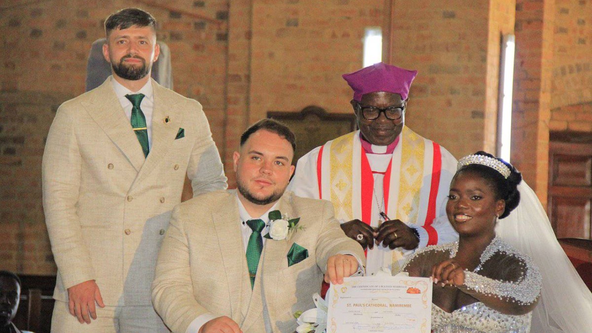 Ben Foster and Leah Nandugga with Bishop Henry Katumba Tamale as they receive their marriage certificate. Ben Foster and Leah Nandugga with Bishop Henry Katumba Tamale as they receive their marriage certificate.