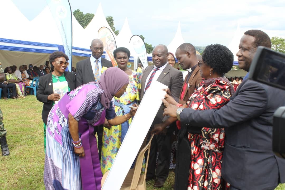 Minister Mariam Mayanja Nkalubo signing on the new theme. Image