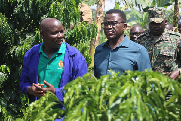 The Katikkiro with one of the coffee farmers in Mawogola. Image