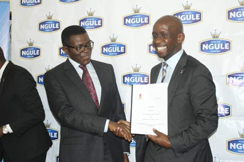 The Katikkiro renewing the contract with Uganda Breweries. Image