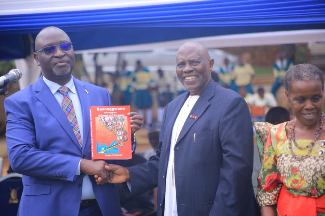 Drake Ssemakula and Hon Robert Waggwa Nsibirwa launching the book. Image