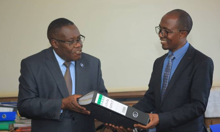 Hon. Joseph Kawuki receiving office from Hon Christopher Bwanika Image