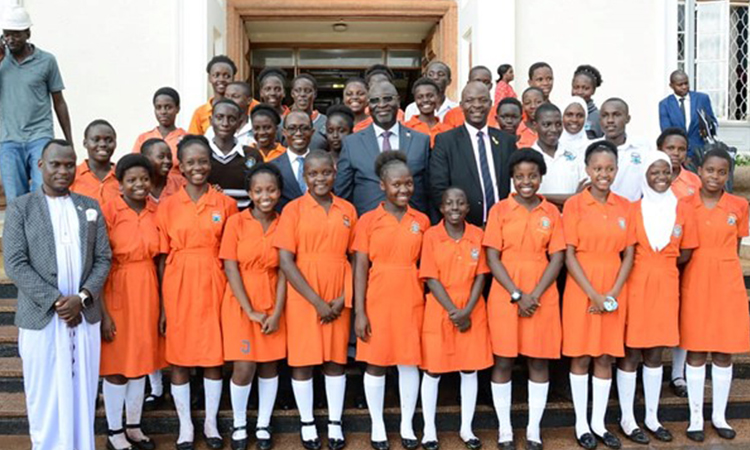 Hon Robert Waggwa with students from St.Janan Image