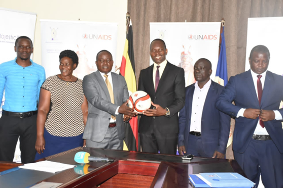 Min. Noah Kiyimba in the middle inaugurating the Clans Football Organizing Committee Image