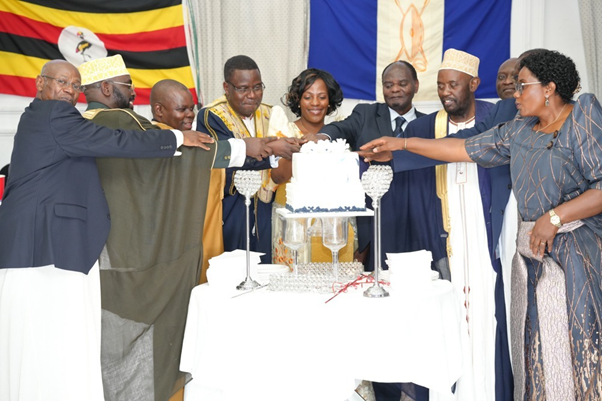 Kabaka’s representative and other guests cutting the cake Image